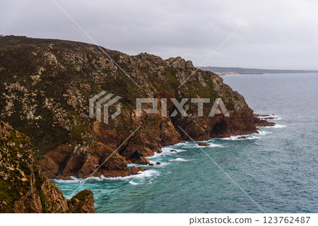 Dramatic cliffs meet the Atlantic Ocean at Cape Roca, Portugal, on an overcast day. 123762487