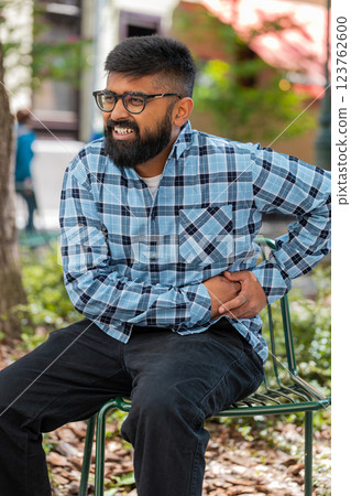 Indian man feeling sudden strong abdominal stomach liver kidney ache gastritis problem diarrhea 123762600