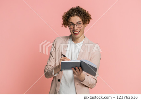 Man making notes writing down thoughts with pen into notepad notebook diary, to do list, good idea Man making notes writing down thoughts with pen into notepad notebook diary, to do list, good idea 123762616