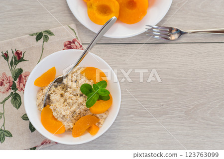Nutritious milk porridge with pieces of sweet peaches 123763099