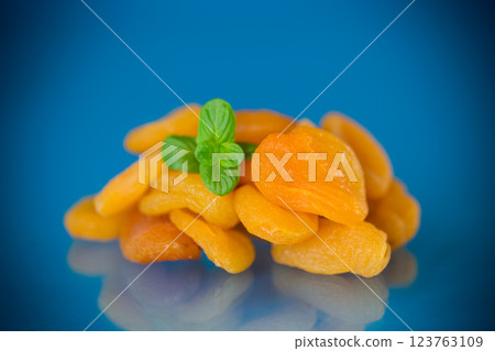 Natural dried apricots with a sprig of fresh mint in a studio shoot 123763109