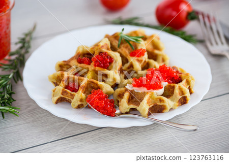 Potato waffles with red caviar on a wooden table Potato waffles with red caviar on a wooden table 123763116