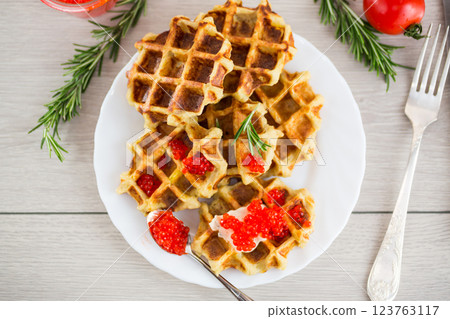 Potato waffles with red caviar on a wooden table 123763117