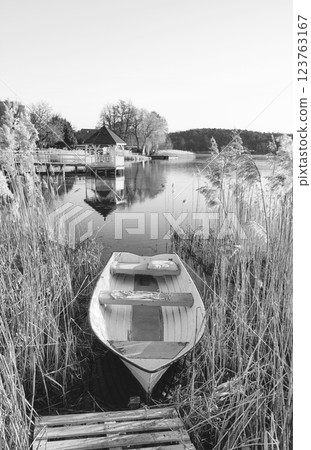 A small boat on the shore of a lake, Barlinek, Poland. 123763167
