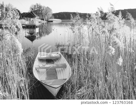 A small fishing boat on the shore of a lake, Barlinek, Poland. A small fishing boat on the shore of a lake, Barlinek, Poland. 123763168