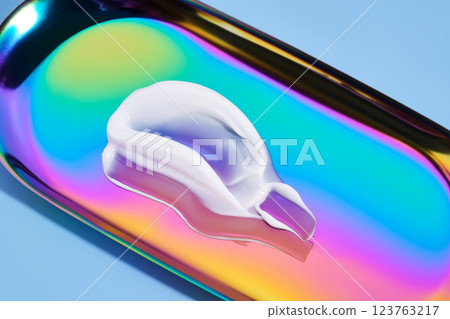 The texture of white cream on a multicolored background. 123763217