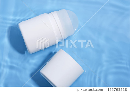Roll-on deodorant on a blue background in water. Roll-on deodorant on a blue background in water. 123763218