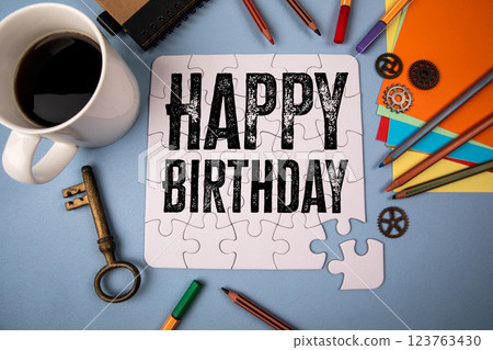 Happy Birthday. White puzzle and office supplies on table 123763430