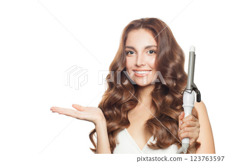 Good-looking woman with healthy long wavy hair  holding empty palm hand  123763597