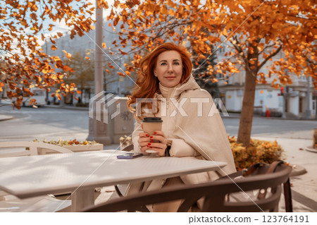 Woman Coffee Autumn: Outdoor Cafe, Fall Season, Relaxing Enjoyment Woman Coffee Autumn: Outdoor Cafe, Fall Season, Relaxing Enjoyment 123764191