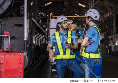 Engineer checking construction process railway and checking work on railroad station . Engineer checking construction process railway and checking work on railroad station . 123764226