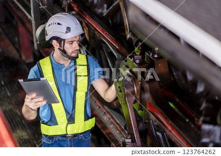 Engineer checking construction process railway and checking work on railroad station .  123764262
