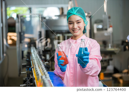 Worker Checking quality or checking stock of glass bottle in beverage factory Worker Checking quality or checking stock of glass bottle in beverage factory 123764400