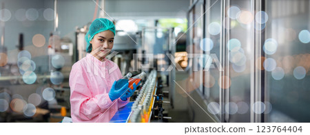 Worker Checking quality or checking stock of glass bottle in beverage factory Worker Checking quality or checking stock of glass bottle in beverage factory 123764404