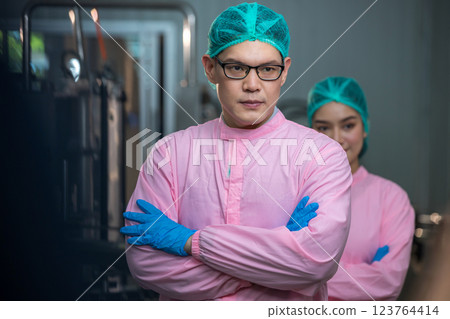 Worker Checking quality or checking stock of glass bottle in beverage factory Worker Checking quality or checking stock of glass bottle in beverage factory 123764414