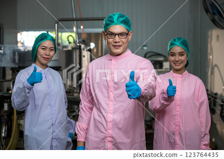 Worker Checking quality or checking stock of glass bottle in beverage factory 123764435