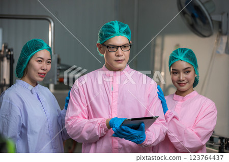 Worker Checking quality or checking stock of glass bottle in beverage factory 123764437