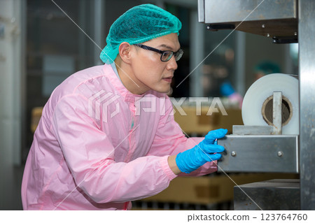 Worker Checking quality or checking stock of glass bottle in beverage factory Worker Checking quality or checking stock of glass bottle in beverage factory 123764760