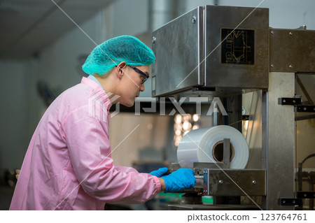 Worker Checking quality or checking stock of glass bottle in beverage factory 123764761
