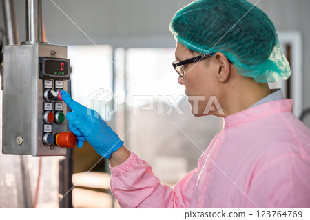 Worker Checking quality or checking stock of glass bottle in beverage factory 123764769