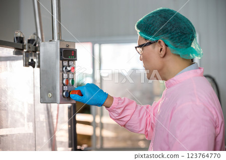 Worker Checking quality or checking stock of glass bottle in beverage factory 123764770