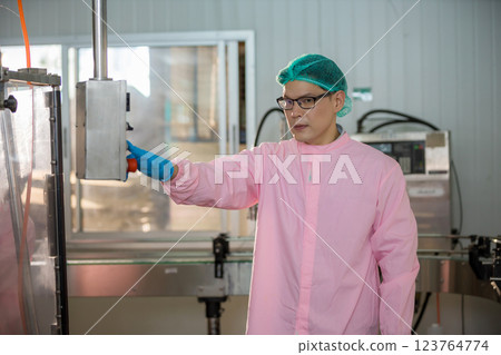 Worker Checking quality or checking stock of glass bottle in beverage factory 123764774