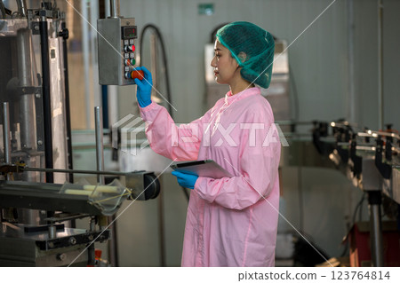 Worker Checking quality or checking stock of glass bottle in beverage factory. 123764814