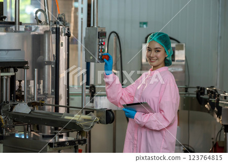Worker Checking quality or checking stock of glass bottle in beverage factory. Worker Checking quality or checking stock of glass bottle in beverage factory. 123764815