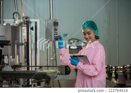 Worker Checking quality or checking stock of glass bottle in beverage factory. 123764816