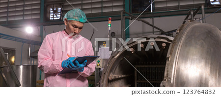 Worker Checking quality or checking stock of glass bottle in beverage factory.  123764832