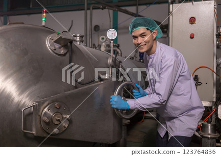 Worker Checking quality or checking stock of glass bottle in beverage factory. Worker Checking quality or checking stock of glass bottle in beverage factory. 123764836