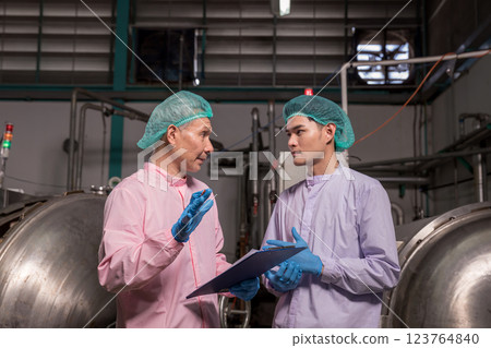 Worker Checking quality or checking stock of glass bottle in beverage factory.  123764840