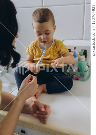 Dental care, mother brushing teeth with boy for wellness,Bathroom, oral health toothbrush 123764925