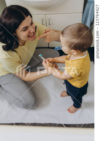Dental care, mother brushing teeth with boy for wellness,Bathroom, oral health toothbrush 123764927