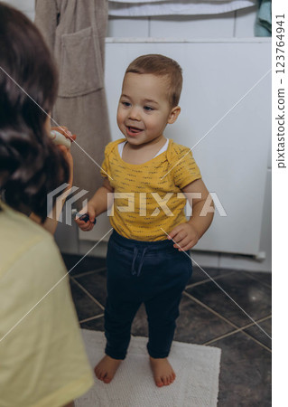 Dental care, mother brushing teeth with boy for wellness,Bathroom, oral health toothbrush Dental care, mother brushing teeth with boy for wellness,Bathroom, oral health toothbrush 123764941