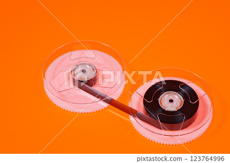 Magnetic tape on reels from a VHS videocassette 123764996