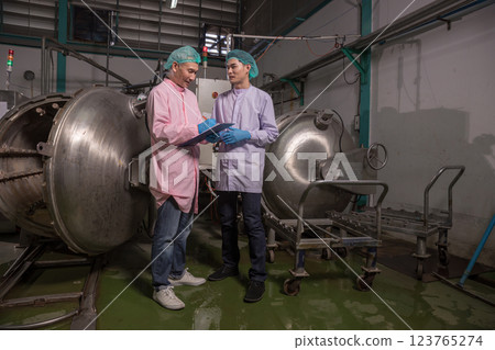 Worker Checking quality or checking stock of glass bottle in beverage factory. Worker Checking quality or checking stock of glass bottle in beverage factory. 123765274