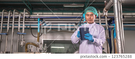 Worker Checking quality or checking stock of glass bottle in beverage factory. Worker Checking quality or checking stock of glass bottle in beverage factory. 123765288
