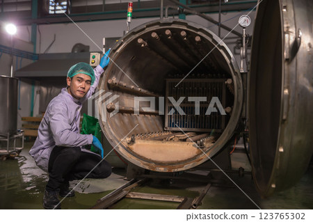 Worker Checking quality or checking stock of glass bottle in beverage factory. Worker Checking quality or checking stock of glass bottle in beverage factory. 123765302