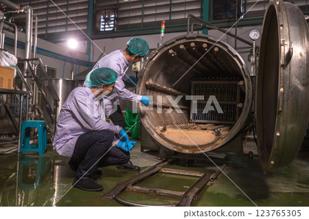 Worker Checking quality or checking stock of glass bottle in beverage factory.  123765305
