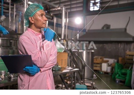 Worker Checking quality or checking stock of glass bottle in beverage factory 123765306