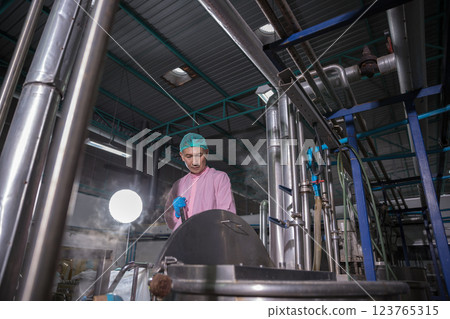 Worker Checking quality or checking stock of glass bottle in beverage factory 123765315