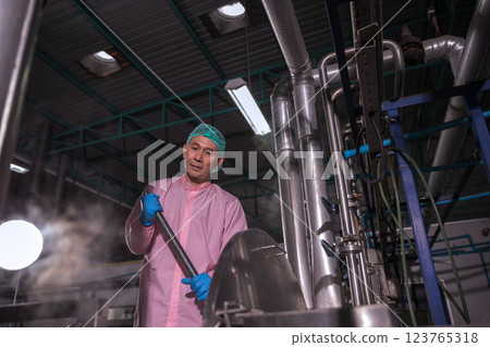 Worker Checking quality or checking stock of glass bottle in beverage factory 123765318