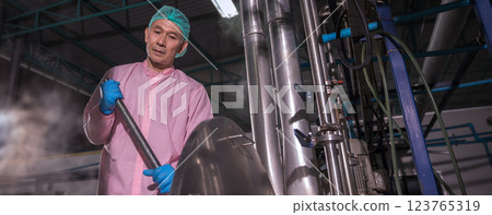 Worker Checking quality or checking stock of glass bottle in beverage factory Worker Checking quality or checking stock of glass bottle in beverage factory 123765319