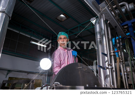 Worker Checking quality or checking stock of glass bottle in beverage factory 123765321