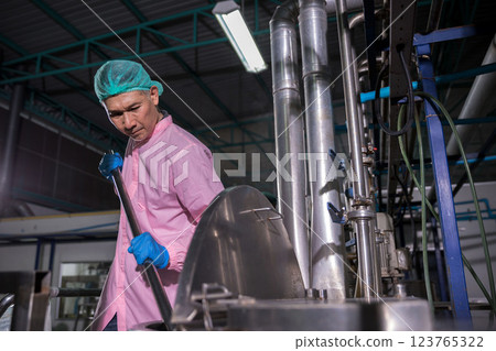 Worker Checking quality or checking stock of glass bottle in beverage factory 123765322