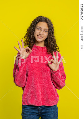 Happy teen girl showing ok gesture, like sign positive feedback, celebrate victory, approve idea Happy teen girl showing ok gesture, like sign positive feedback, celebrate victory, approve idea 123765633