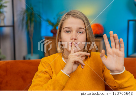 Teenager child boy presses finger to lips makes silence hush sign do not tell gossip secret, quiet Teenager child boy presses finger to lips makes silence hush sign do not tell gossip secret, quiet 123765648