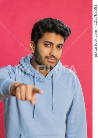 Happy Indian smiling man pointing finger to camera making winner choice, showing direction, select Happy Indian smiling man pointing finger to camera making winner choice, showing direction, select 123765681
