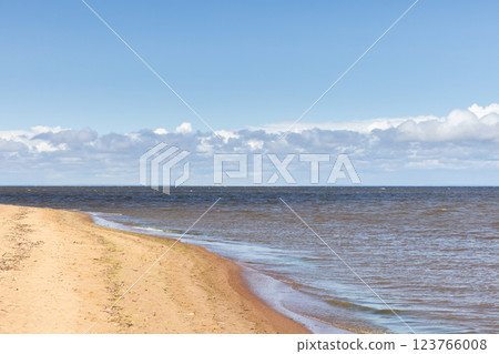 Tranquil beach scenery showcasing a peaceful coastline Tranquil beach scenery showcasing a peaceful coastline 123766008
